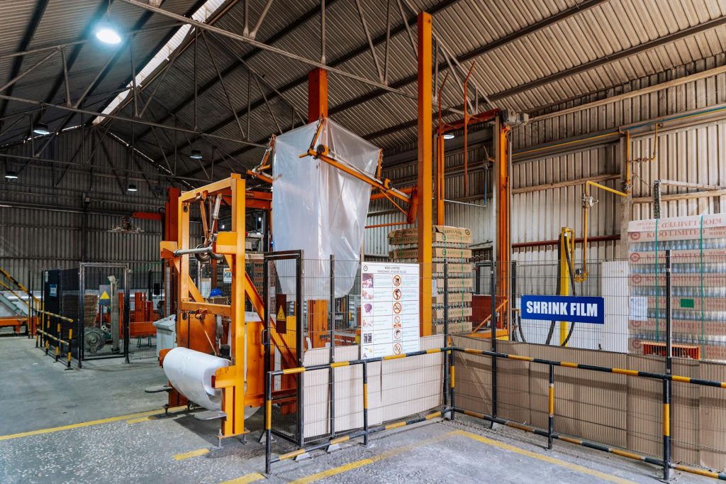 Interior view of a warehouse in Dar es Salaam with a shrink film machine and industrial eq